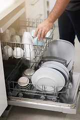 Image showing Cleaning, loading dishwasher and hands with dishes in the kitchen for housework and responsibility. Lifestyle, morning and a person doing housekeeping, organizing crockery and clean equipment