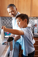 Image showing Home, father and son washing dishes, family and help with development, cleaning and chores. Male parent, dad and son in the kitchen, teaching skills and growth with bonding, learning and cooperation