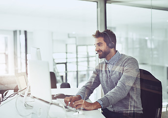 Image showing Call center, typing and business man on computer in office for customer service. Telemarketing, smile and male person on pc, sales agent or consultant working for support, consulting and help online.