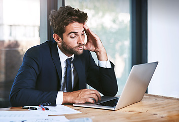 Image showing Tired, laptop and stress businessman lazy with a headache in an office typing on a computer online or the internet. Sleepy, burnout and depressed male corporate person writing a report or research