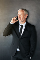 Image showing Happy businessman, phone call and thinking with communication, contact and network in studio. A senior entrepreneur person on a grey background with a smartphone for conversation and connection