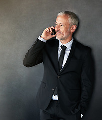 Image showing Thinking, happy and businessman on a phone call for communication, contact and network in studio. Senior entrepreneur person on grey background with a smartphone for conversation, mockup or idea