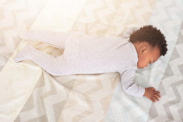 Image showing Top view, bedroom and baby sleeping in home for rest, nap time and dreaming in nursery blanket. Childcare, newborn and above of cute, tired and African child in bed sleep for comfort, relax and calm