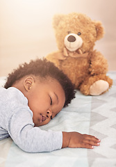 Image showing Sleeping, teddy bear and dreaming with baby in bedroom for carefree, development and innocence. Cute, relax and comfortable with african infant and toy resting at home for morning, nap and bedtime