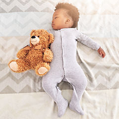 Image showing Top view, teddy bear and baby sleeping in bed for rest, nap time and dreaming in nursery. Childcare, newborn and cute, tired and African child with toy in bedroom sleep for comfort, relax and calm