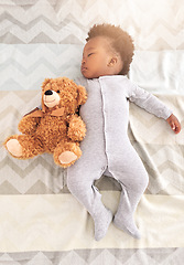 Image showing Teddy bear, bed and baby sleeping in home with lens flare for rest, nap time and dreaming in nursery. Childcare, newborn and cute, tired and African child in bedroom sleep for comfort, relax and calm