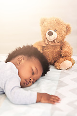 Image showing Sleeping, teddy bear and tired with baby in bedroom for carefree, development and innocence. Dreaming, relax and comfortable with african infant and toy at home for morning, resting and bedtime