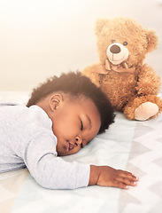 Image showing Sleeping, teddy bear and relax with baby in bedroom for carefree, development and innocence. Dreaming, cute and comfortable with african infant and toy at home for morning, resting and bedtime
