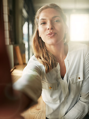 Image showing Selfie, woman and kiss pose at cafe, coffee shop or restaurant and happy, lips and portrait of morning routine. Female person, face and pout or flirt, photograph for social media or profile picture