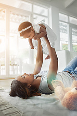 Image showing Happy black woman, baby and playing on floor with love, teddy bear and smile together in living room. Happiness, mother and daughter in flying bonding, quality time for parent and newborn in home.