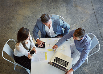 Image showing Top view, business and employees with planning, teamwork and collaboration in the workplace. Staff, group and coworkers with a laptop, brainstorming and share ideas with conversation and development