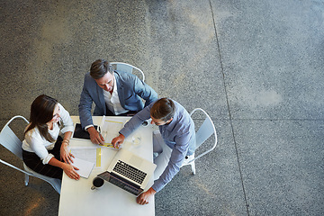 Image showing Top view, business and team planning, technology and teamwork in the workplace, collaboration and brainstorming. Group, coworkers and employees share ideas, laptop and meeting for a new project