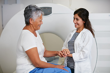 Image showing Doctor, ct scan and woman holding hands of patient in hospital before scanning in machine. Mri, comfort and happy medical professional with senior female person before radiology test for healthcare.