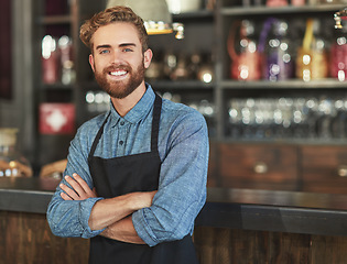 Image showing Happy, barista and portrait of man in a coffee shop by the counter in his startup cafeteria. Smile, confidence and small business owner or waiter with crossed arms and success in his new restaurant.