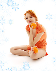 Image showing cheerful redhead with two oranges