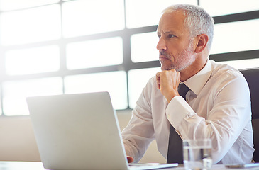 Image showing Laptop, thinking and research with a business man in the office, working online to finish a project at his desk. Computer, idea and email with a mature male manager at work for company opportunity