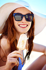 Image showing Popsicle, smile and portrait of woman at beach on vacation, holiday and travel in summer hat. Happiness, ice cream and female tourist eating by ocean shore enjoying snack in Australia with sunglasses