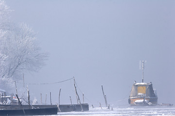 Image showing old boats frozen in ice on River Danube mid winter