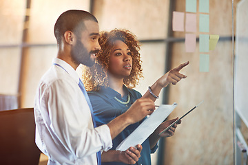 Image showing Teamwork, brainstorming or planning on tablet in modern office for strategy conversation and sticky notes. Businesspeople, talking and moodboard or idea, document and corporate company workplace