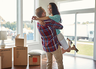 Image showing Happy couple, keys and moving into new home or hug for mortgage or property buy and boxes in empty lounge together. Real estate, man and woman excited for rent or embrace and house with open space