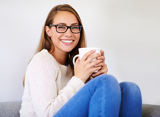 Image showing Portrait, coffee and smile of woman in home enjoying caffeine, espresso or cappuccino in living room. Happiness, tea and female person with glasses on sofa, drinking beverage and relax in house alone