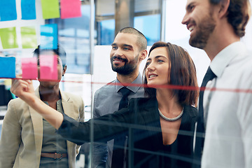 Image showing Teamwork, collaboration of diverse coworkers with sticky notes on wall and working in office. Startup or project, support or communication and team planning together discussing plans or ideas at work