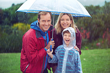 Image showing Happy family, child and portrait in rain with umbrella in nature outdoor for fun, happiness and quality time. Man, woman and boy kid laughing for water drops or freedom while playing in winter