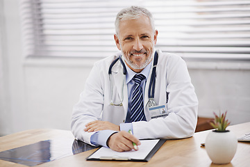 Image showing Healthcare, portrait and male doctor with a clipboard in his office analyzing xray document in hospital. Confidence, smile and professional mature man medical worker with paperwork by desk in clinic.