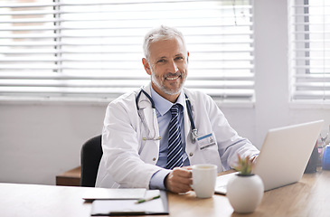 Image showing Happy, laptop and portrait of a male doctor in his office doing diagnosis research in a hospital. Confidence, success and professional mature man healthcare worker with a computer in medical clinic.