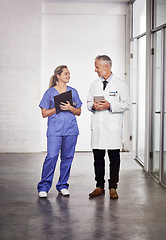 Image showing Doctor, healthcare and medical team talking in a hospital a clipboard and tablet for health insurance. Senior chief and nurse or a man and woman together for a discussion, results and planning