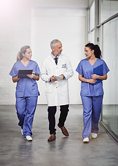 Image showing Medical team, healthcare and doctors talking in a hospital with a clipboard and tablet for health insurance. Senior chief and nurses or a man and women together for a discussion, results and planning