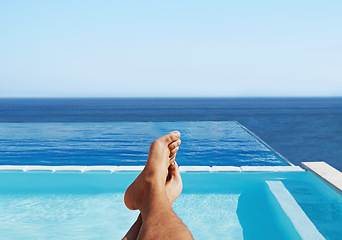 Image showing POV, feet and man relax at a pool for travel and summer vacation at the sea by hotel and water. Barefoot, calm and traveling person outdoor at poolside holiday or rest at luxury resort in Maldives