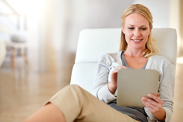 Image showing Happy woman, tablet and smile in living room for social media, research or browsing on chair at home. Female person smiling and relaxing on technology for communication or online search at the house