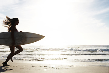 Image showing Silhouette, woman surfer run on beach sand and sea, exercise outdoor with surfboard to surf in nature. Sport, shadow and sun with female person running to ocean waves for surfing and mockup space