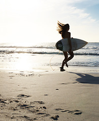 Image showing Silhouette, woman surfer running on beach sand and sea, exercise outdoor with surfboard to surf in nature. Sports, shadow and sun with female person run to ocean waves for surfing and mockup space