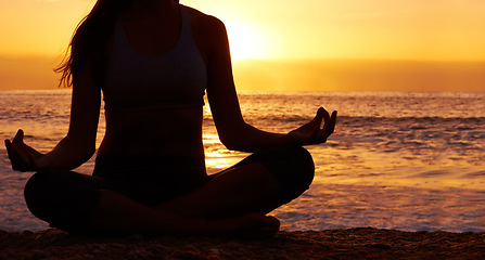 Image showing Silhouette, sunset and woman in lotus pose with yoga on the beach, orange sky and meditation outdoor. Healing, wellness and peace in nature with shadow, female yogi back and meditate by the ocean