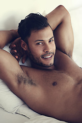 Image showing Portrait, smile and morning with a sexy man in bed, shirtless after a rest to relax while ready to wake up. Face, happy and body with a handsome or sensual young male model lying topless in a bedroom