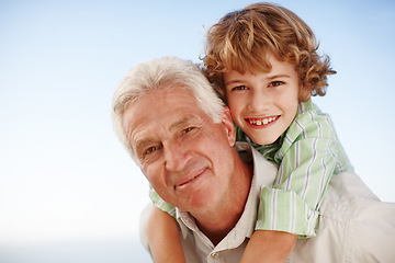 Image showing Piggyback, face of grandfather with child and happy outdoors in blue sky. Portrait of family love, quality time and cheerful grandparent with young boy outside in nature for freedom or summer holiday