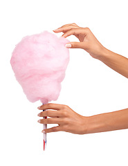 Image showing Candy floss, sweet and woman hands isolated on a white background for eating, pink food and holiday treat. Person hand holding cotton, color cone for youth birthday, childhood and festival in studio