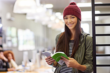 Image showing Woman with smile in portrait, student in library reading book and study for exam on university campus. Education, learning and academic development with female person holding textbook for knowledge