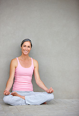 Image showing Yoga, mockup and portrait of old woman in lotus pose on floor for meditation, healing and balance on wall background. Mindfulness, face and happy elderly lady with space in retirement for wellness