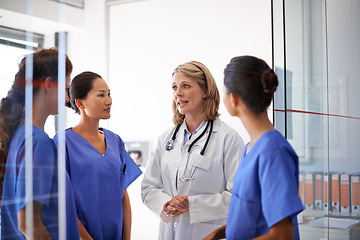 Image showing Team, discussion and woman doctor or medical professionals on healthcare planning or wellness analysis in hospital. Leader, meeting and mature nurse or student staff for collaboration and clinic