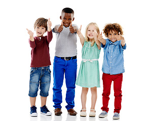 Image showing Children, group and together for thumbs up in studio portrait with smile, agreement and white background. Girl, boy or isolated friends for happiness, hand like or solidarity for kids with diversity