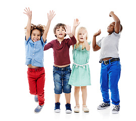 Image showing Joy, jumping and portrait of children in studio for diversity, friends and playing. Happiness, youth and smile with group of kids isolated on white background for celebration, playful and energy