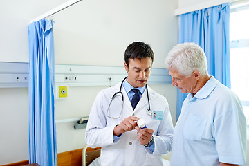 Image showing Consultation on pills, doctor and old man at hospital with advice, help and support at senior care clinic. Retirement, discussion on medicine and elderly patient on bed with medical professional.