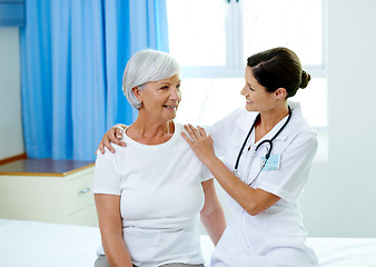 Image showing Happy consultation, nurse and old woman in hospital room for advice, help and support at senior care clinic. Retirement caregiver, counselling and elderly patient with smile on bed with female doctor