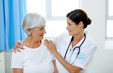 Image showing Consultation, doctor and old woman in hospital for advice, help and support at senior care clinic. Retirement, counselling discussion and nursing home, happy elderly patient sitting on bed with nurse