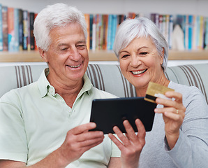 Image showing Happy senior couple, tablet and credit card for online shopping on living room sofa together at home. Elderly man and woman smiling on technology for ecommerce, banking app or payment on lounge couch