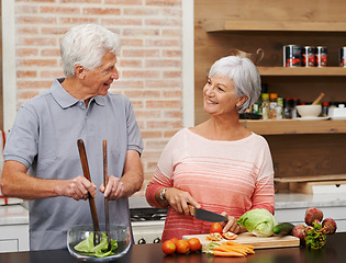 Image showing Cooking, health and help with old couple in kitchen for salad, love and nutrition. Happy, smile and retirement with senior man and woman cutting vegetables at home for food, dinner and recipe