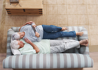 Image showing Top view, senior couple and sofa with tablet, social media, online news app and ebook in lounge. Happy old man, woman and relax with digital technology, subscription or website on internet connection